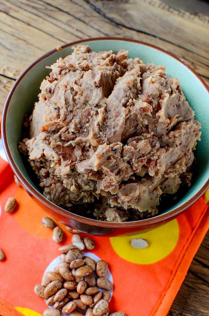 Super easy Homemade Crock Pot Refried Beans Recipe! Perfect for Mexican night, taco night, or burritos! This slow cooker recipe makes family dinners quick and easy to prepare!