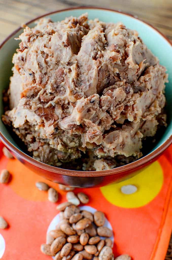 Super easy Homemade Crock Pot Refried Beans Recipe! Perfect for Mexican night, taco night, or burritos! This slow cooker recipe makes family dinners quick and easy to prepare!