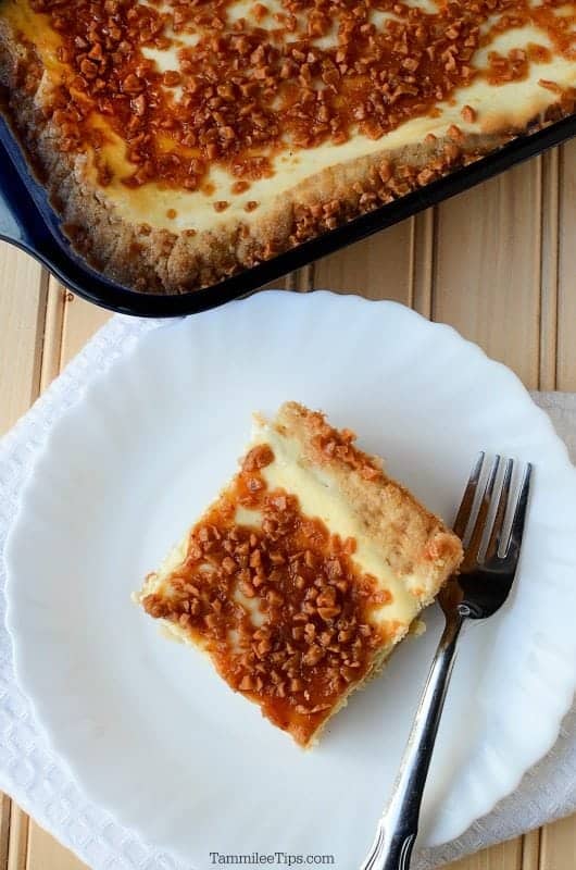  Creme Brulee Cheese Cake Bars on a white plate with a fork 