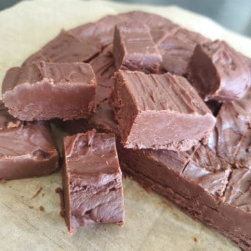 Famous Carnation Fudge stacked on parchment paper