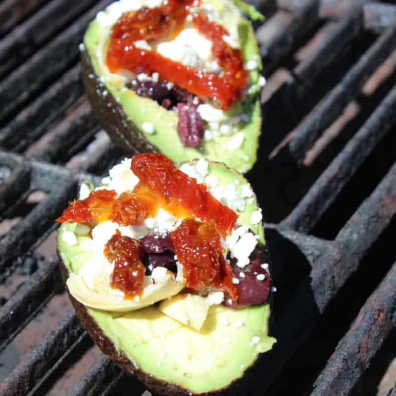 Grilled avocados with sundried tomatoes, feta, and kalamata olives
