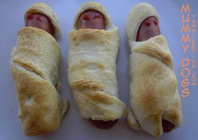 three crescent wrapped hot dogs with mummy dogs text down the side