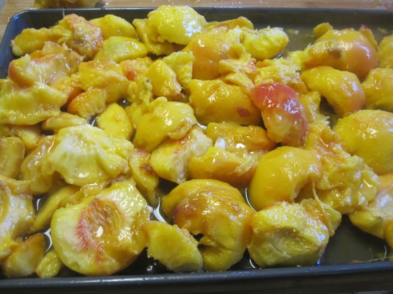 peach pieces on a baking sheet