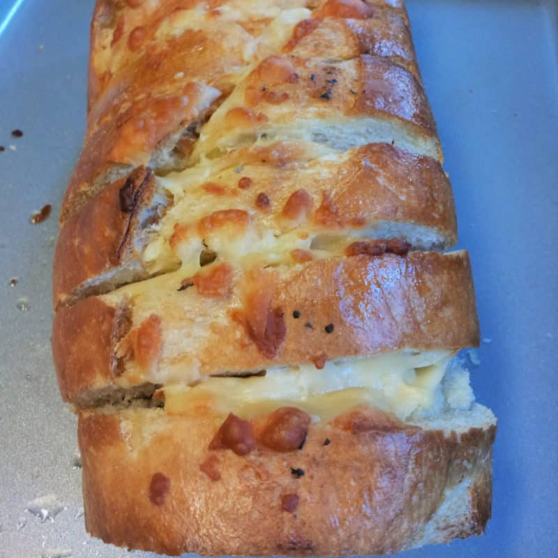 cheesy garlic bread on a baking sheet