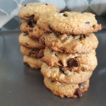 Cake Mix Chocolate Chip Cookies stacked on a baking sheet