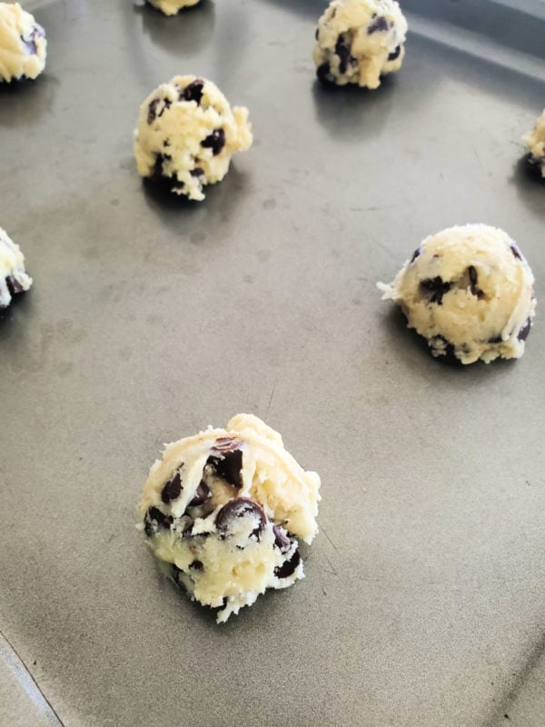 Chocolate Chip Cake Mix Cookie dough balls on a metal baking sheet