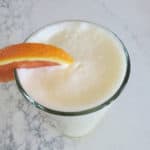 Copy Cat Orange Julius in a tall glass with an orange garnish