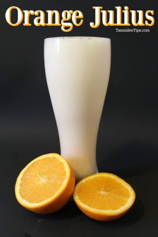 Orange Julius above a tall glass with oranges at the base