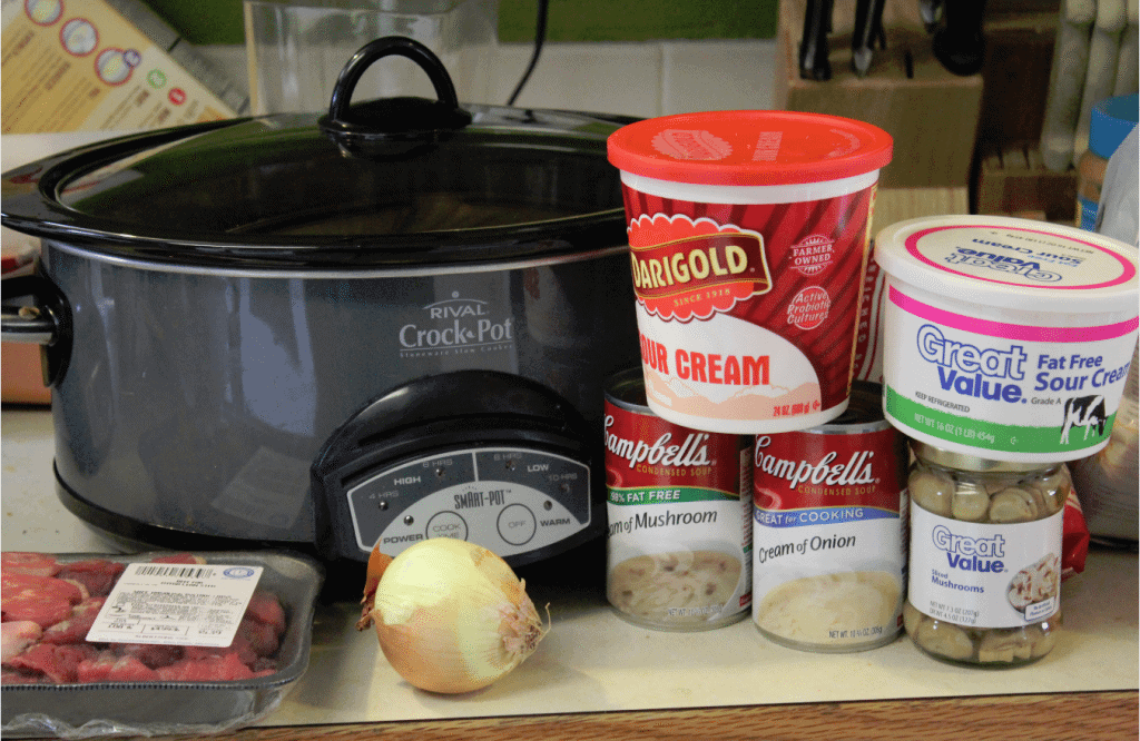 Crock Pot Beef Stroganoff Recipe ingredients, Beef stew meat, onion, cream of onion soup, mushrooms, sour cream, egg noodles