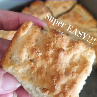 7 Up biscuits super easy text over a square 7-up biscuit being held above the pan of biscuits