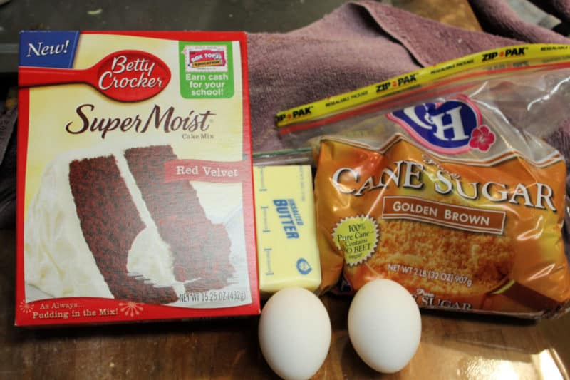 Red Velvet cake mix, eggs, butter, and brown sugar on a counter