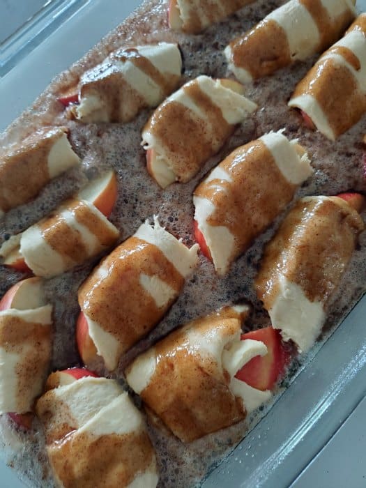 apples wrapped in crescent rolls with liquid on them. 