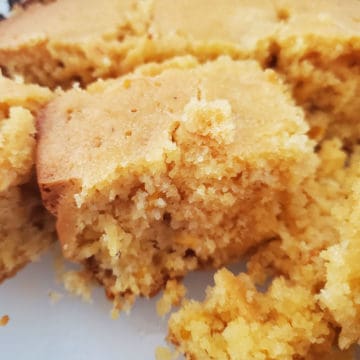 squares of crockpot cornbread on a white platter