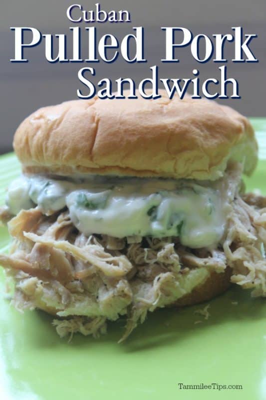 Cuban Pulled Pork Sandwich over a green plate with a pulled pork sandwich