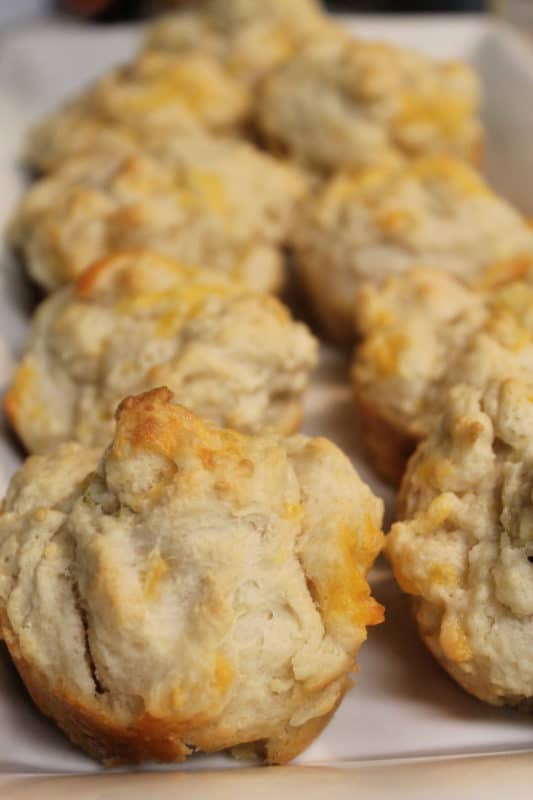 Garlic cheese muffins on a white platter