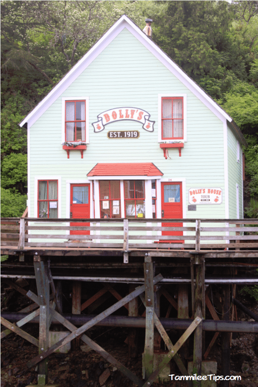 Dolly's Established 1919 on a green building with red doors and windows