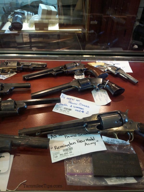 Historic guns on display with price tags