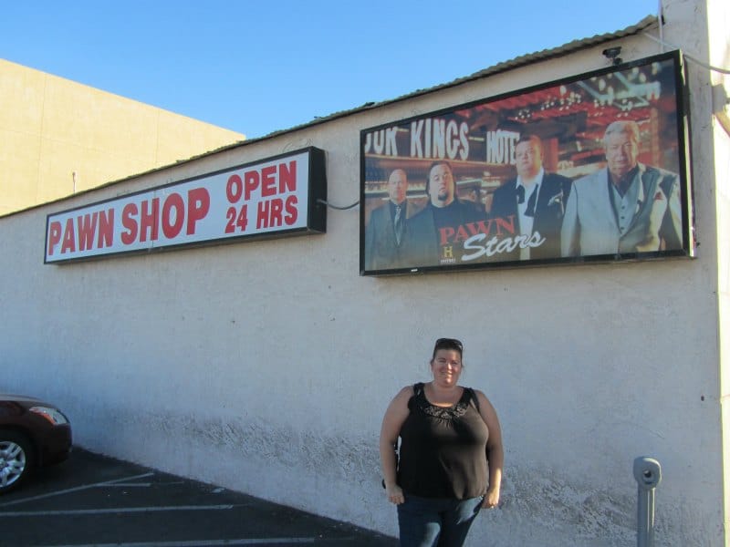 Tammilee standing near a Pawn Stars sign and Pawn Shop sign