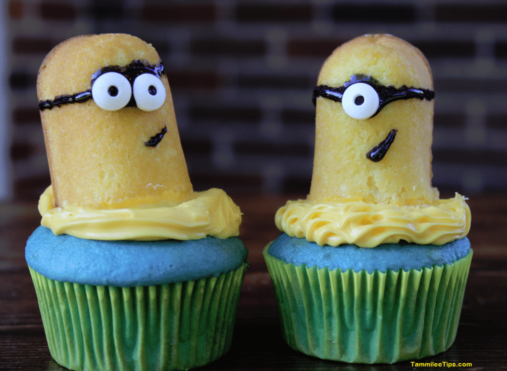 Two Minions cupcakes on a wood board
