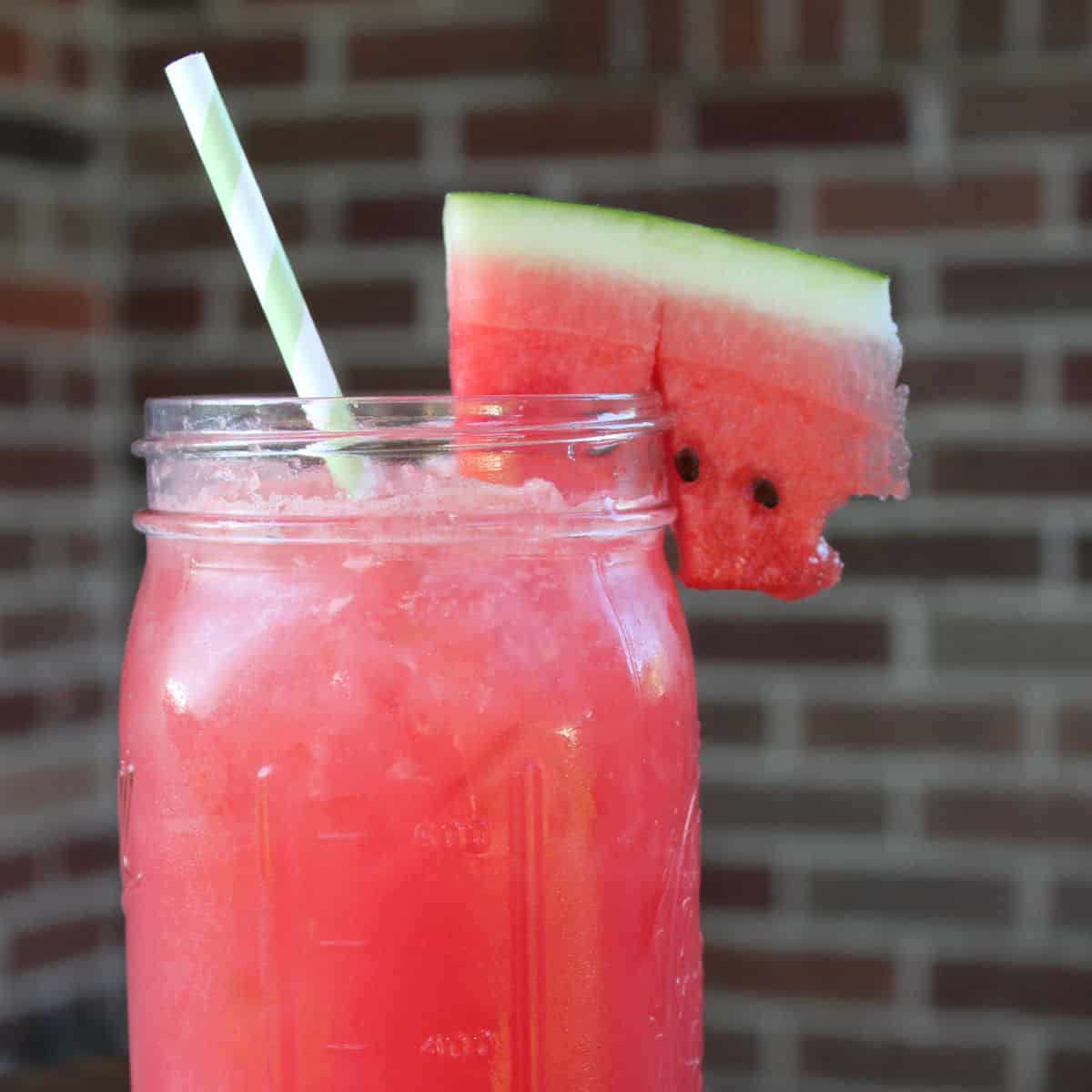 Watermelon Agua Fresca in a mason jar with a watermelon slice