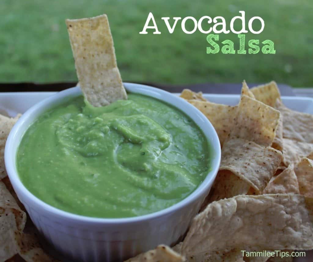 Avocado Salsa in a white bowl with tortilla chips surrounding it