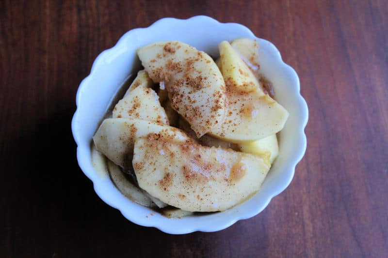 Boston Market Apples with Cinnamon in a white bowl on a wood background