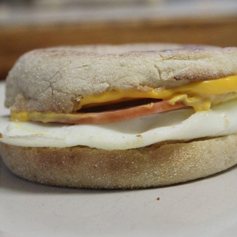 copycat egg mcmuffin with an English muffin, egg, slice of ham, and cheese