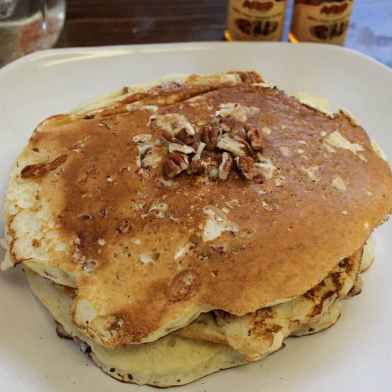 Stack of copycat Cracker Barrel Pecan Pancakes on a white plate