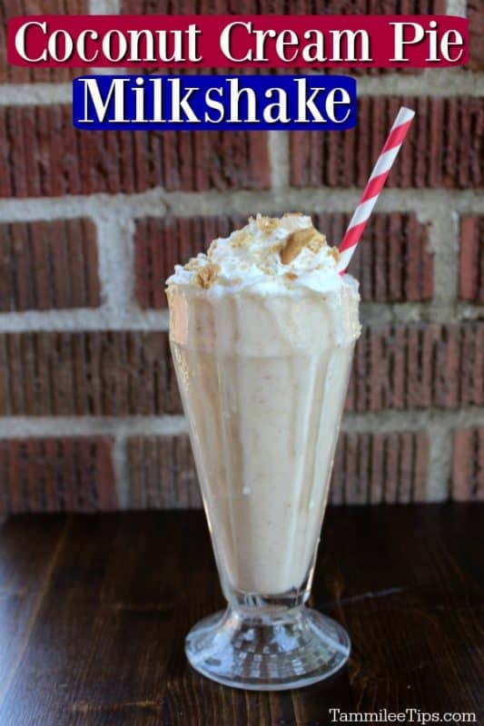 sonic coconut cream pie shake in a clear glass with a pink and white striped straw against a brick background