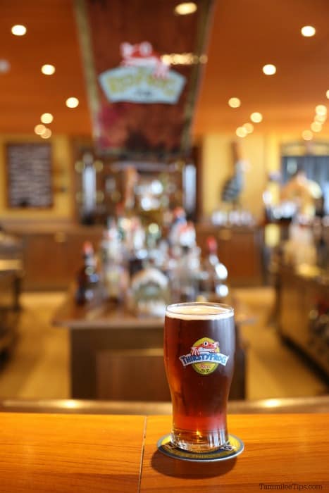 Thirsty Frog Beer Glass on a bar with Red Frog Pub in the background