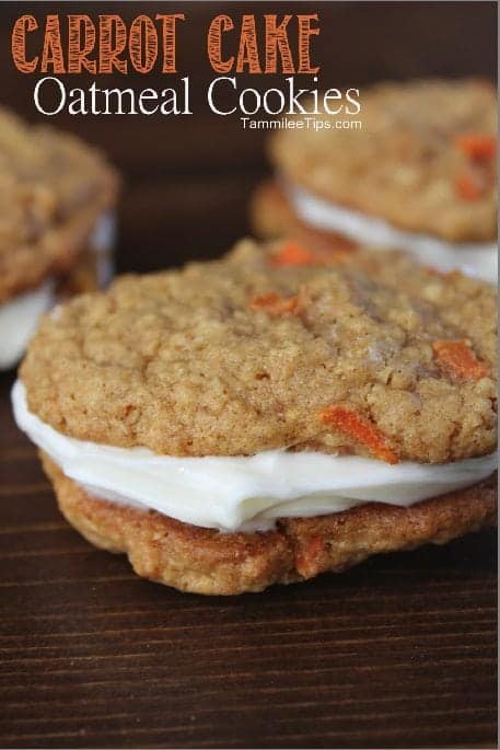 Carrot Cake Oatmeal Cookies text over the top of the photo with 3 carrot oatmeal cookies on a dark wood board