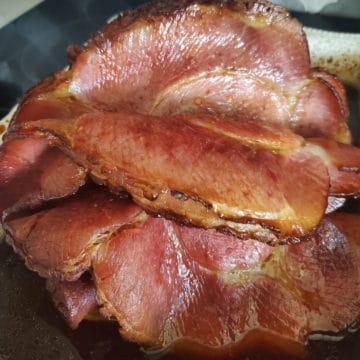 sliced bourbon honey ham in a baking dish