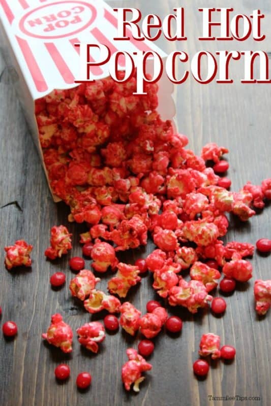 Red Hot Popcorn text over a popcorn container spilling out red popcorn and candies