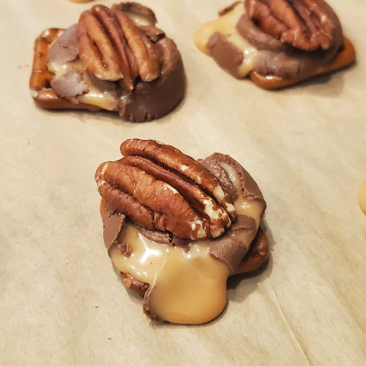 3 Ingredient Rolo Pretzel Turtles on parchment paper