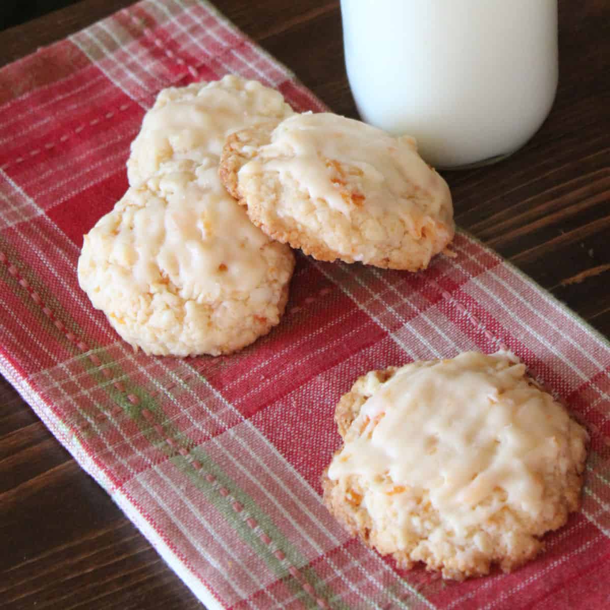 Apricot Cookies on a red patterned napkin by a glass of milk