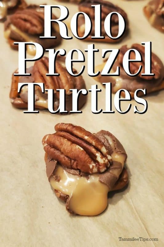 Rolo Pretzel Turtles on parchment paper with caramel coming out over the pretzel, pecan on top