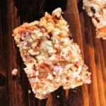 Crock Pot 7 Layer Bar on a wooden board