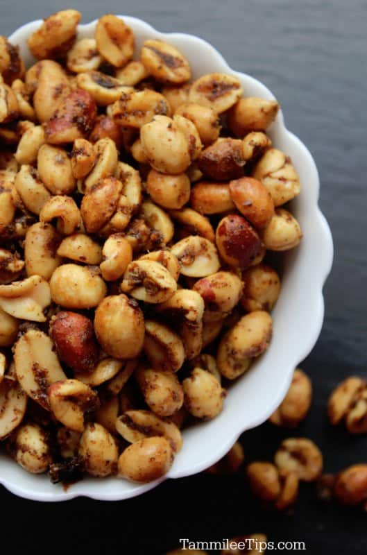 Chili nuts in a white bowl on a dark background