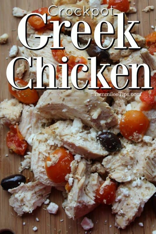 Crockpot Greek Chicken over a wood platter with chicken, tomatoes, and kalamata olives