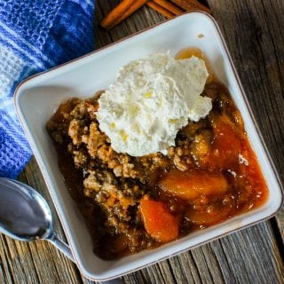 Super easy Crock Pot Apple Spice Dump Cake Recipe! This recipe uses pie filling, cake mix, and a few other ingredients to make a delicious fall dessert slow cooker recipe!