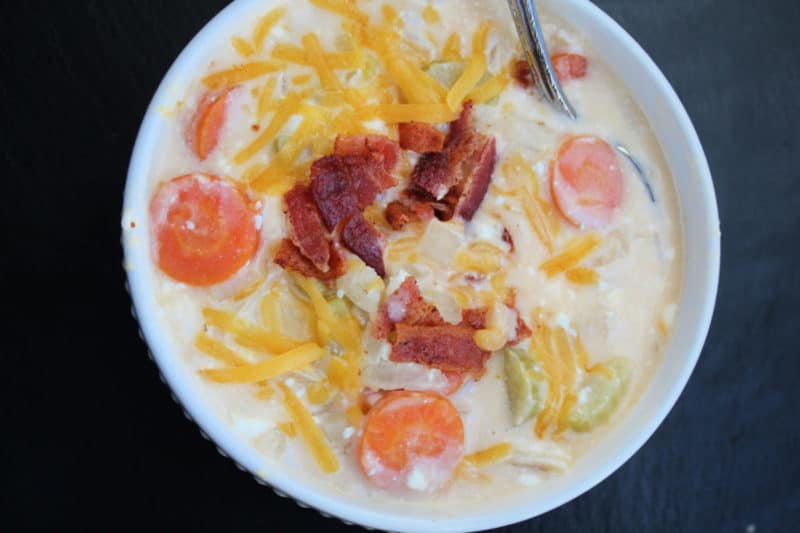 Slow Cooker beer cheese soup in a white bowl with a spoon in it