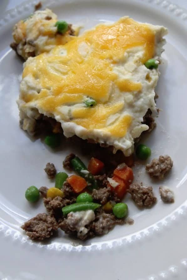Serving of shepherds pie on a white plate 