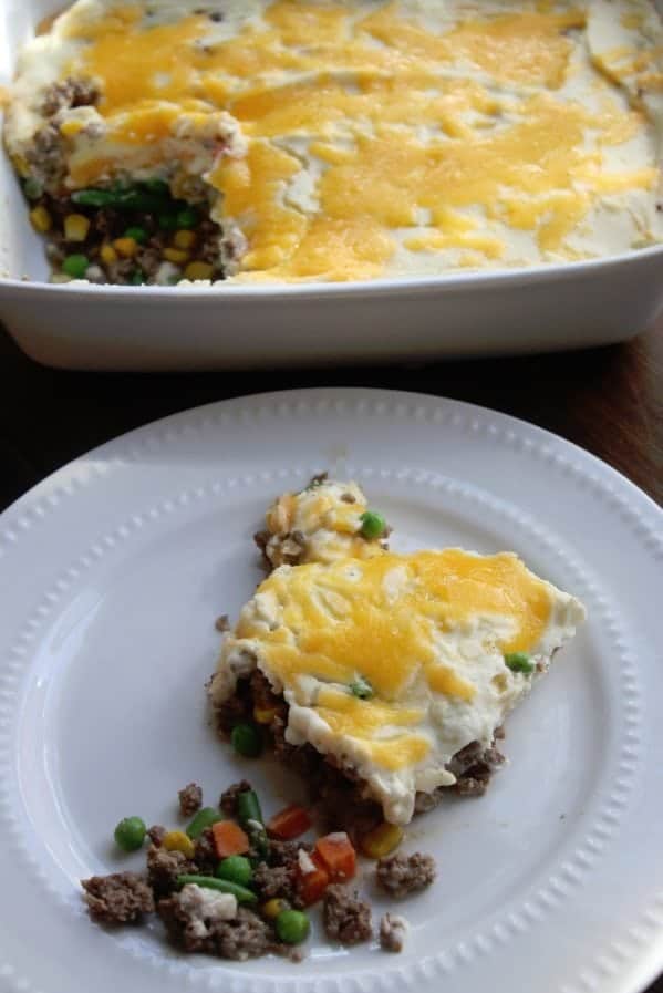 serving of Shepherd pie on a white plate next to the baking dish