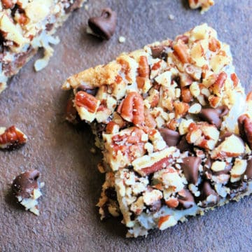 Chocolate Coconut 5 Layer Bar on a dark board