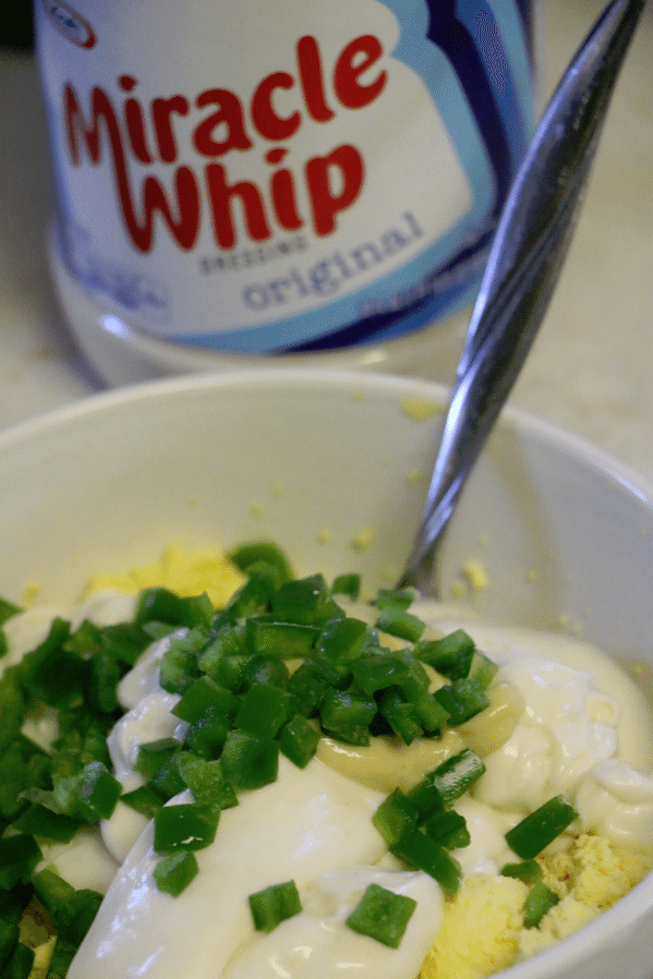 Egg yolks in a bowl mashed with ingredients