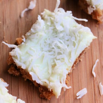 key lime pie bar square on a wood cutting board