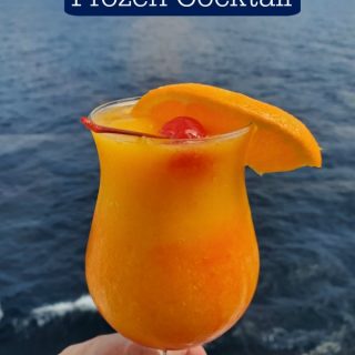 Kiss on the Lips frozen cocktail text over a frozen drink in a hurricane glass with an orange wedge and cherry