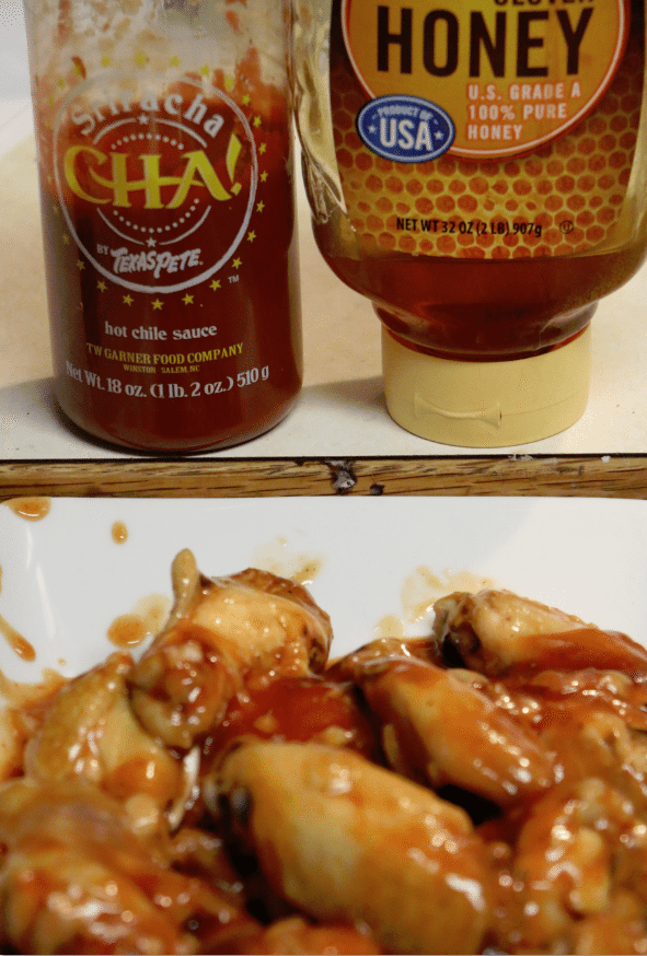 Chicken wings on a platter next to Sriracha Cha by Texas Pete and a honey container