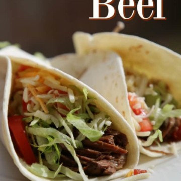 Chipotle Shredded Beef text over two beef tacos