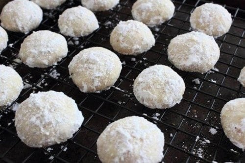 Snowball cookies on a metal drying rack 